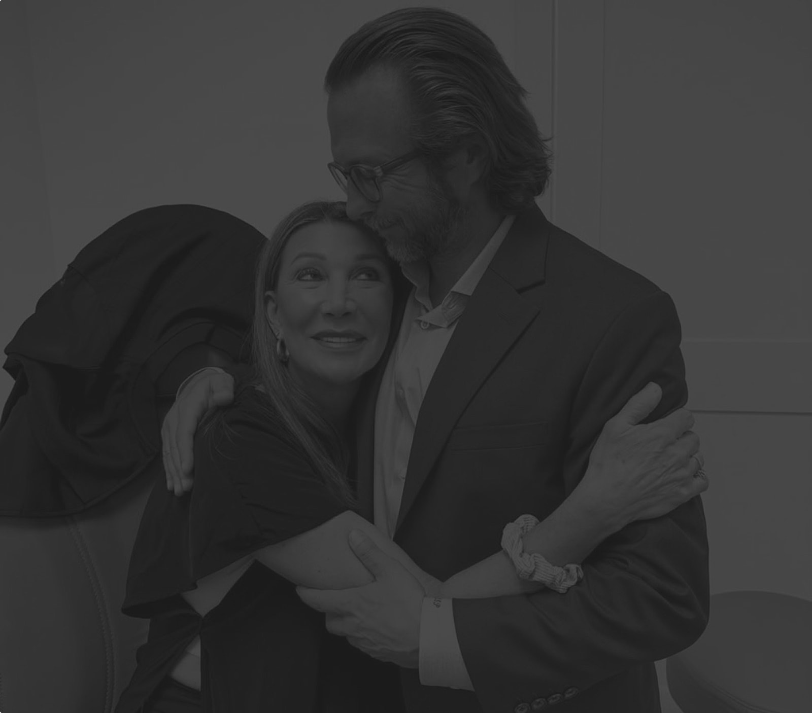 Couple embracing, smiling in a close moment.