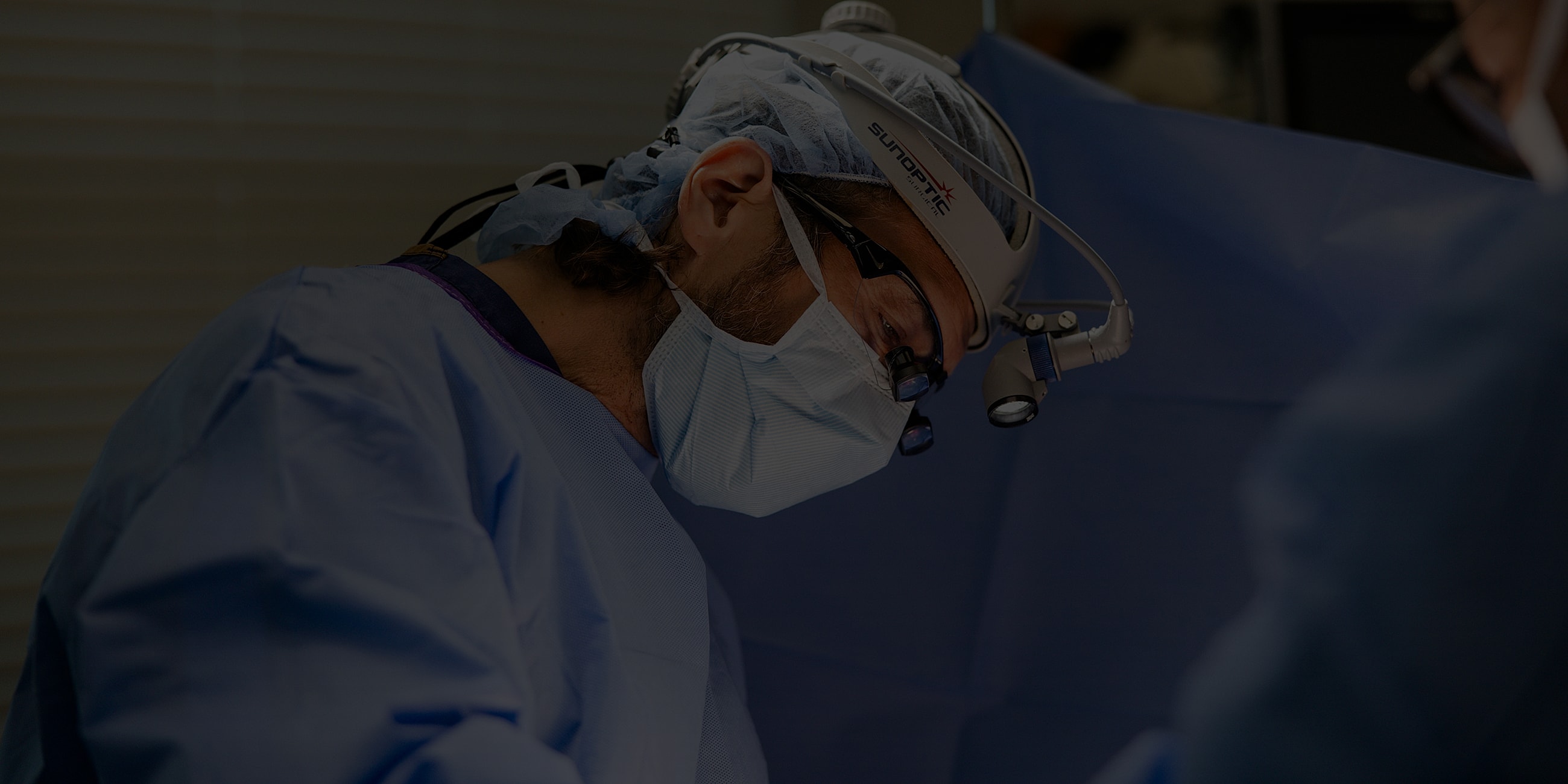 Surgeon focused on procedure in operating room.